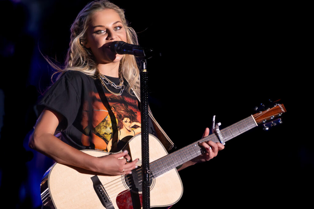 Kelsea Ballerini singing and playing acoustic guitar 