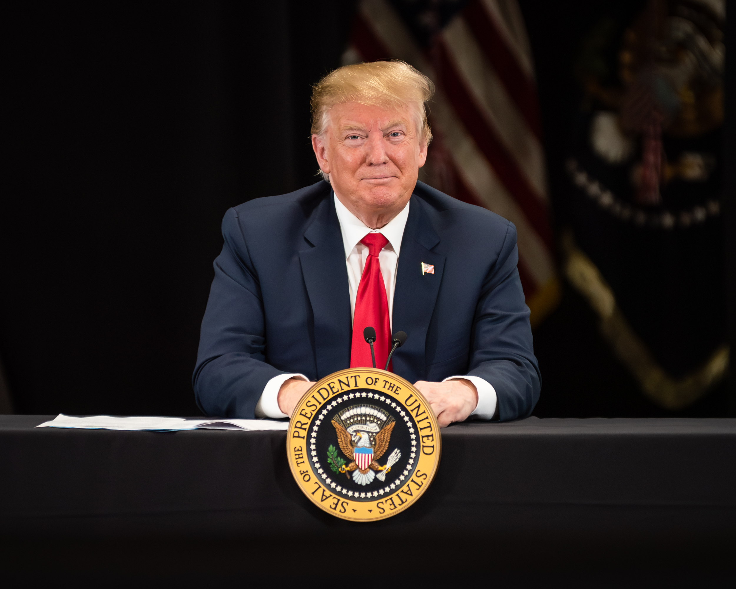 President Donald Trump behind presidential seal